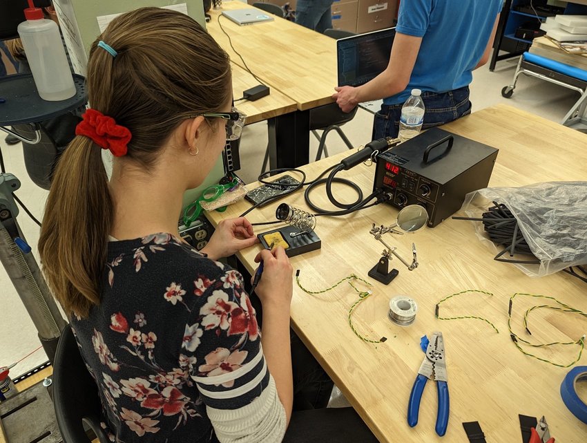 Conifer robotics team member Maddie Potter begins working on a robot that the Denver East High School team could use at a competition on March 23, a day after a shooting at the school.